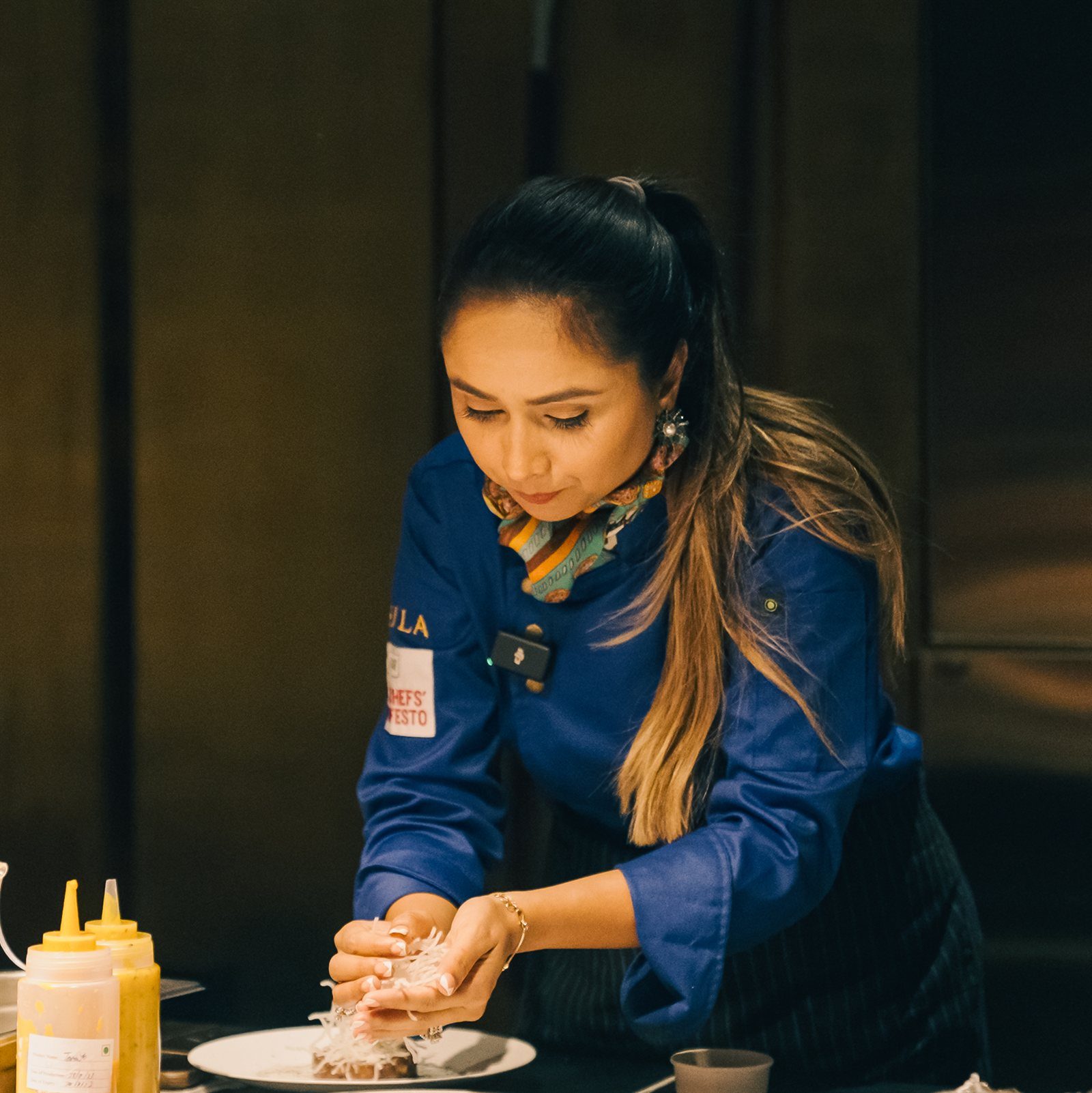 Sakirat Waraich plating a dish at a Chefs' Manifesto event.